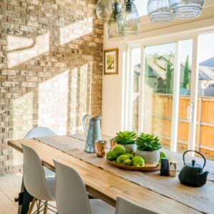 Black Kettle Beside Condiment Shakers and Green Fruits and Plants on Tray on Brown Wooden Table